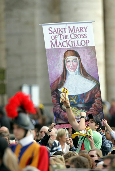 Canonisation ceremony: Australian pilgrims hold a banner showing Sister Mary MacKillop 
