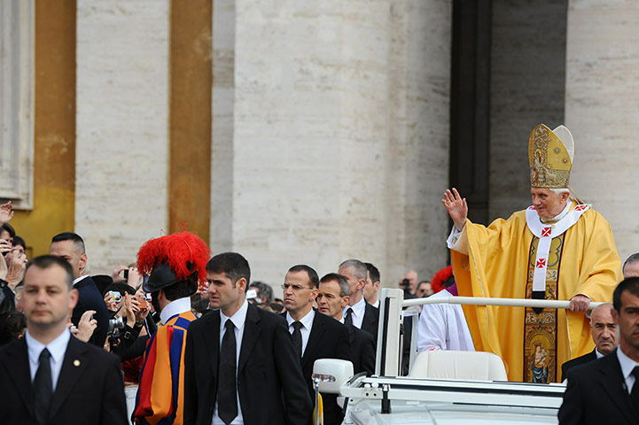 Canonisation ceremony: Pope Benedict XVI waves to the faithful as he arrives 