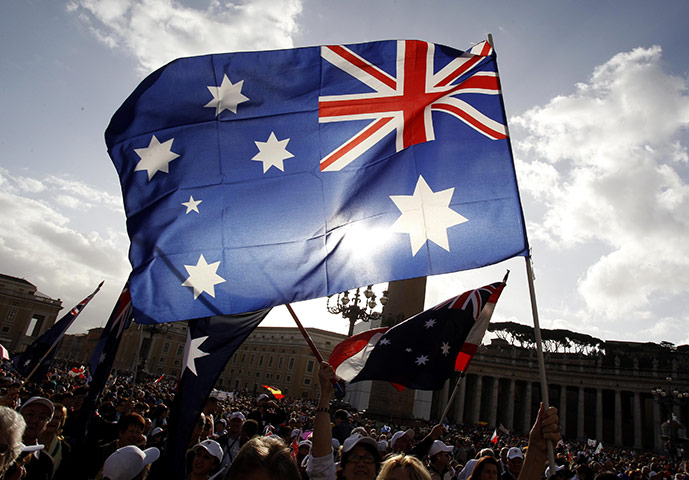 Canonisation ceremony: Australian pilgrims wave flags before a solemn mass