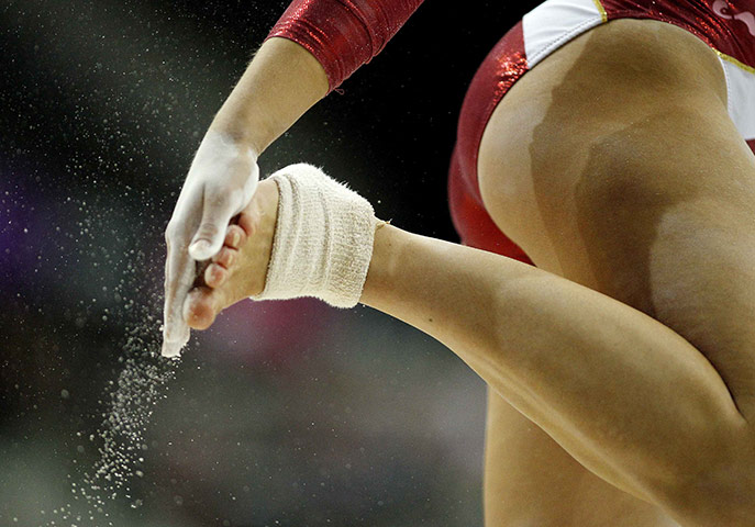 Gymnastics championships: Canada's Bianca Dancose-Giambattisto powders her feet before she performs 