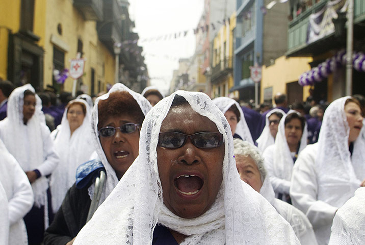 24 hours: Lima, Peru: Woman sings religious chants during procession 