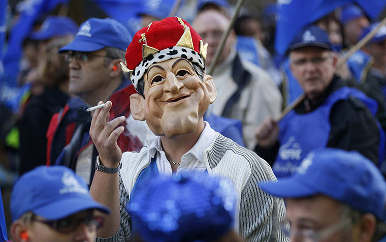 strikes in france: A man wears a mask of  President Sarkozy 