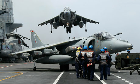 A Harrier jet lands on the flight deck of HMS Ark Royal