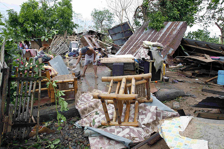 Typhoon Megi : A resident cooks rice after Typhoon Megi hit the town of Ilagan