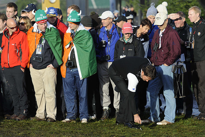 Ryder Cup Day 2: Graeme McDowell pick and drop his ball from the muddy rough on the 14th