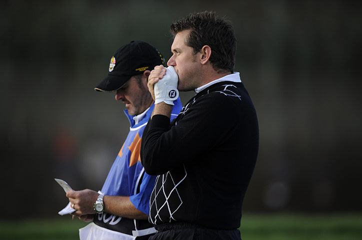 Ryder Cup Day 2: Lee Westwood blows on his hands to keep warm 