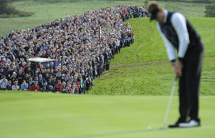 Ryder Cup Day 2: A huge crowd watches Ian Poulter line up a putt on the 16th