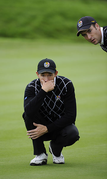 Day 2 Ryder Cup: Padraig Harrington lines up a putt for his partner Ross Fisher on the 3rd