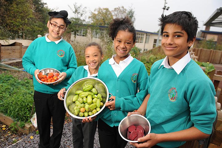 Teaching Awards 2010: Four pupils hold fruit and vegetables ready for composting