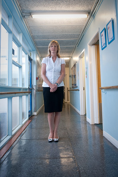 Teaching Awards 2010: A woman stands alone in corridor 