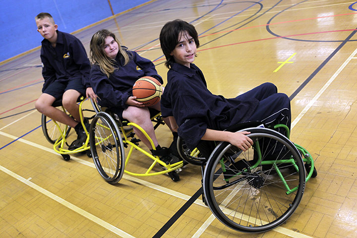 Teaching Awards 2010: Three pupils in wheelchairs pose on the basketball court.