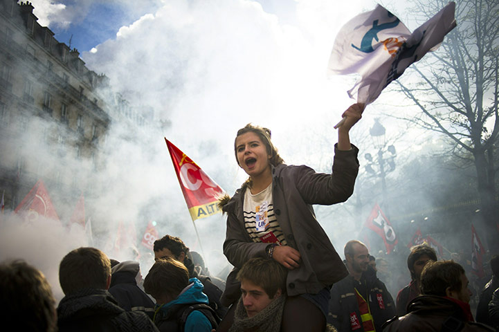 French strikes Wed: A high school student waves a flag during a demonstration in paris
