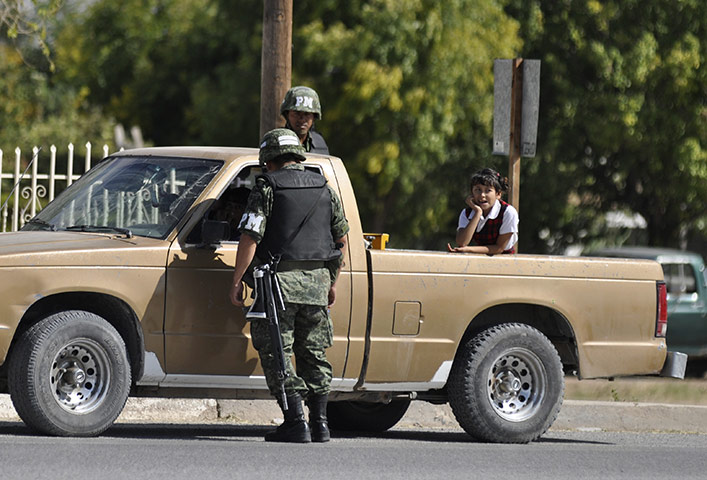 Marisol Valles: Soldiers man a checkpoint hours in the border town of Praxedis G. Guerrero