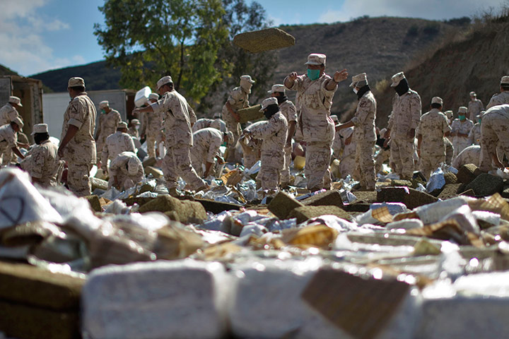 24 hours: Soldiers work on packages of seized marijuana in Tijuana, Mexico