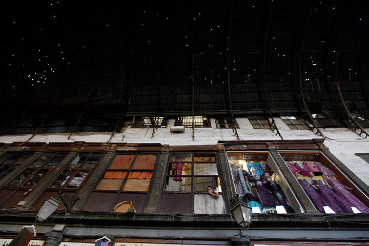 24 hours: A Syrian salesman  is seen sits at his window shop