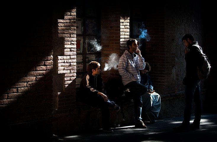 24 hours: Students smoke at the courtyard of their university in Barcelona, Spain
