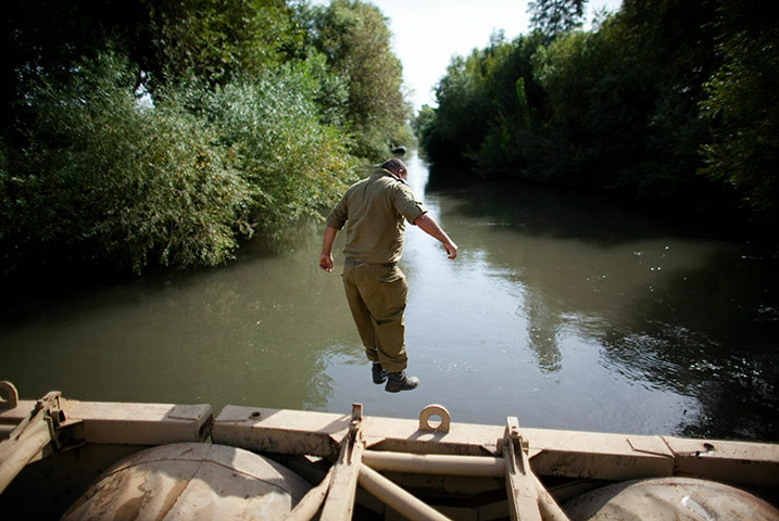 24 hours: An Israeli soldier jumps into the water as troops take part in an exercise