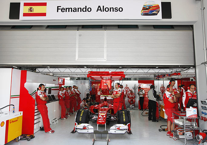 Korean Grand Prix: Fernando Alonso and his mechanics wait in their garage 