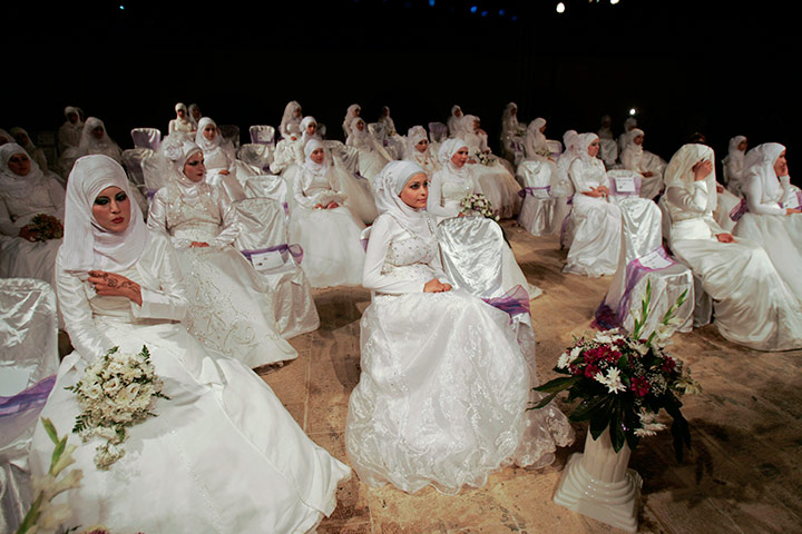 24 hours: Palestinian brides take part in a mass wedding ceremony in the West Bank