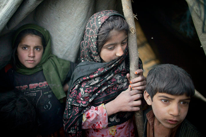 24 hours: fghan children, from Kapisa province, stand in a tent camp 