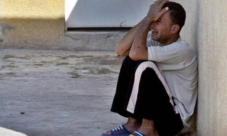 An Iraqi cries outside a hospital in the restive city of Baquba on 17 October 2006