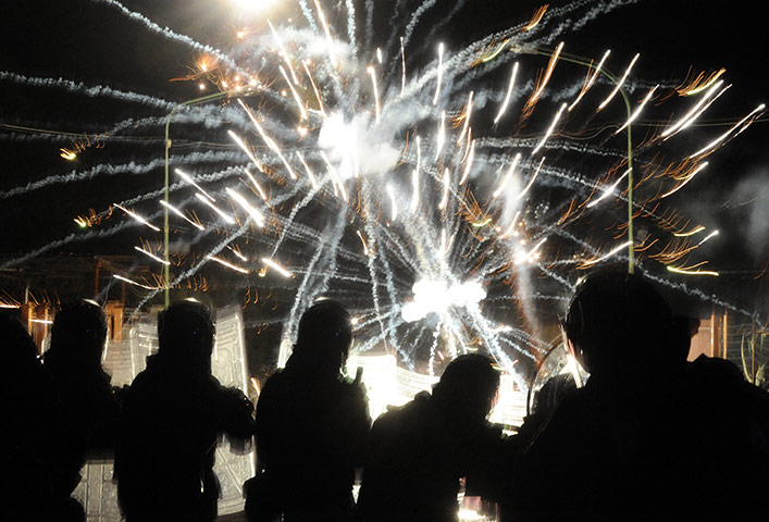 24 Hours in Pictures: Italian police take cover as demonstrators aim firecrackers at them