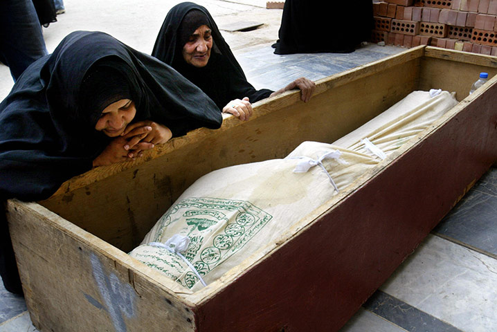 A Day in Iraq: Iraqi women mourn over the coffin of their relative in Najaf