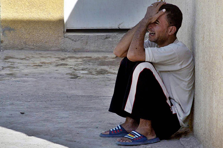A Day in Iraq: An Iraqi cries outside a hospital in the restive city of Baquba