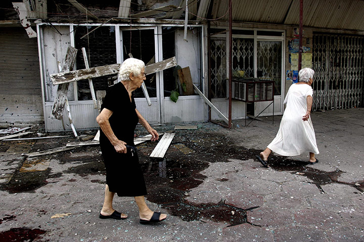 A Day in Iraq: Two elderly Iraqi women walk in the Al Wathiq square hit by a mortar attack