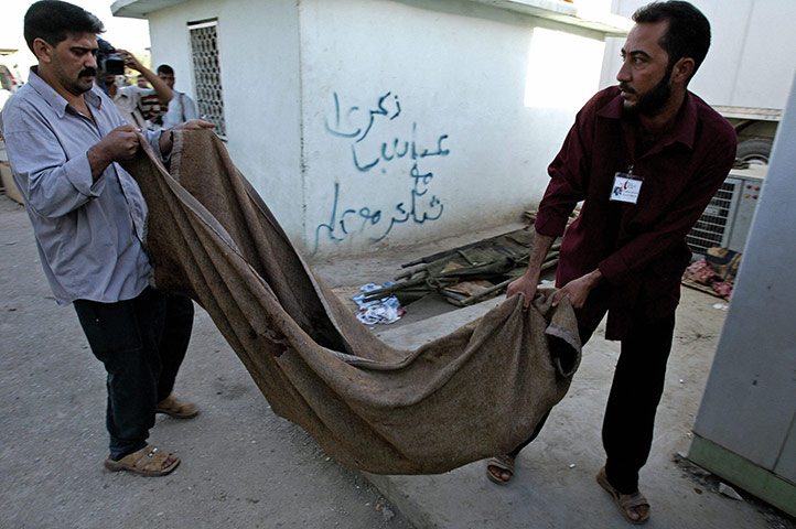 A Day in Iraq: Iraqis carry a body out of the morgue of a hospital in Baghdad