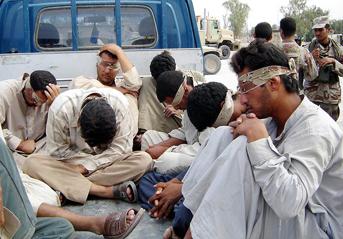 A Day in Iraq: Blindfolded terrorist suspects are brought to Iraqi army base in Baqouba