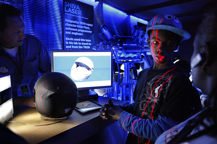 24 hours: Washington, USA: Lasers sweep over William Atkinson in a Tron Legacy booth