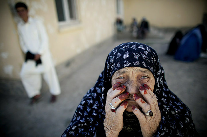 24 hours: Dasht-e-Barchi, Afghanistan: An elderly woman waits for eye treatment 