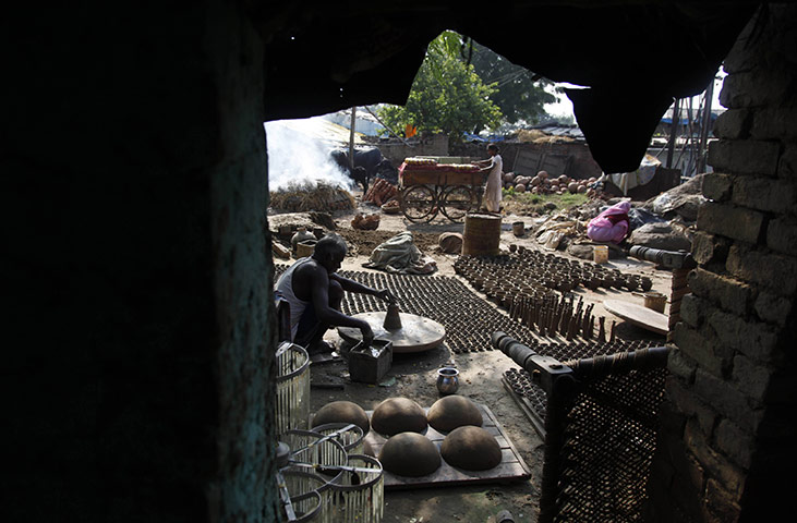 24 hours: Allahabad, India: An Indian potter makes earthen lamps ahead of Diwali 