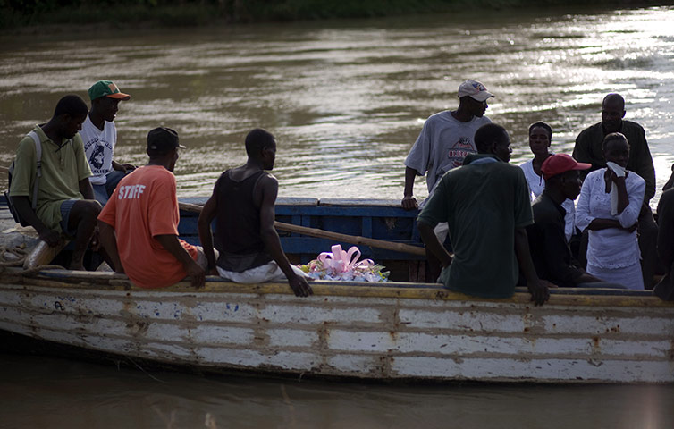 24 hours: Robine, Haiti: People with the coffin of a relative who died of cholera 