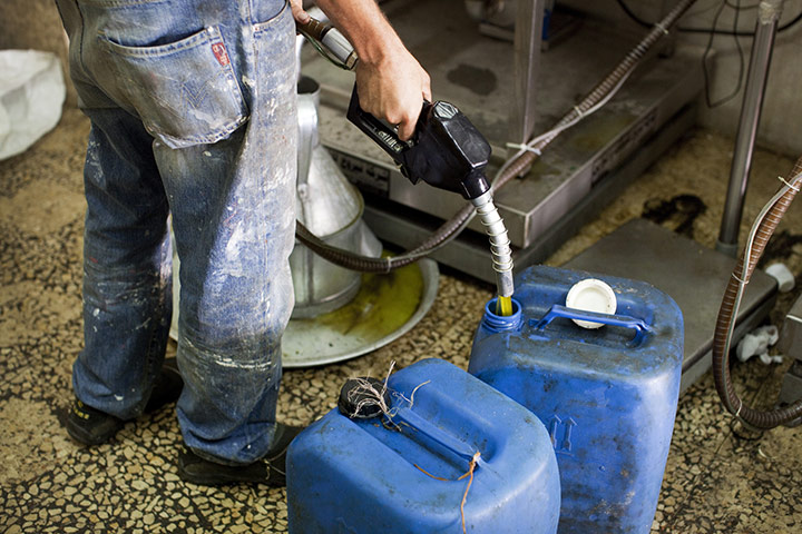 West Bank olive harvest: Filling containers with olive oil for local consumers