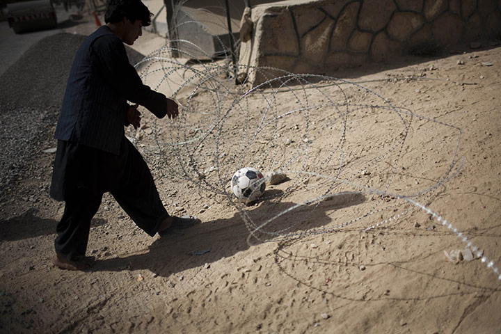 24 hours in pictures: brabed wire outside police station in kandahar, afghanistan
