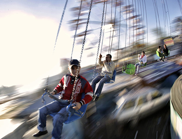 24 hours in pictures: Bolintin, Romania: Children enjoy a ride at a fair 