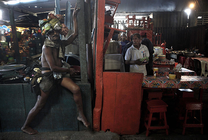 24 hours: A homeless man sits next to a restaurant at the oriental market