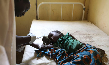 A doctor treats a child suffering from cholera