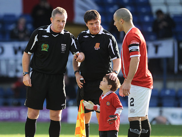 FC United: The young FC United of Manchester mascot looks up at referee Mr M Heywood