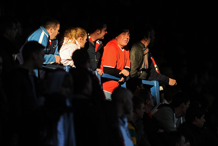 FC United: An FC United fan looks on as the sun fades and full time approaches