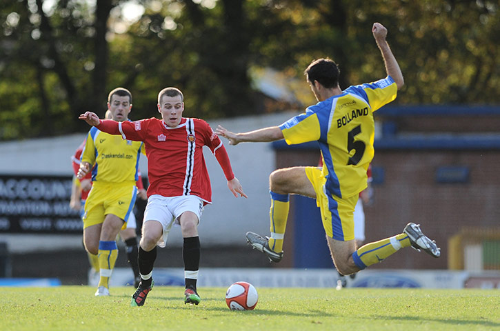 FC United: Jake Cotterell tries to get to the ball ahead of Phil Bolland of Barrow AFC