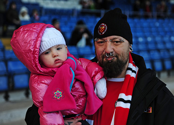 FC United: An FC United of Manchester fan poses for a photograph with his baby