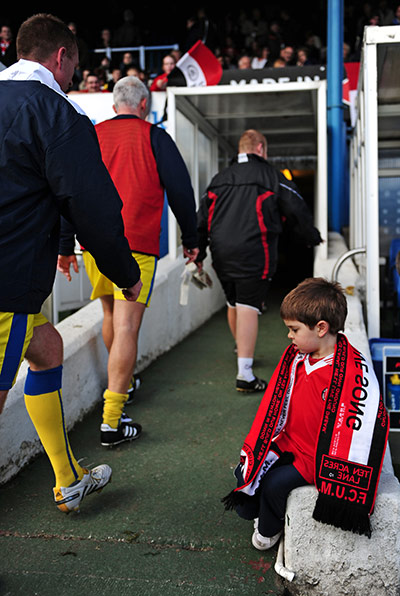 FC United: The young FC United mascot admires the boots of the Barrow AFC players 