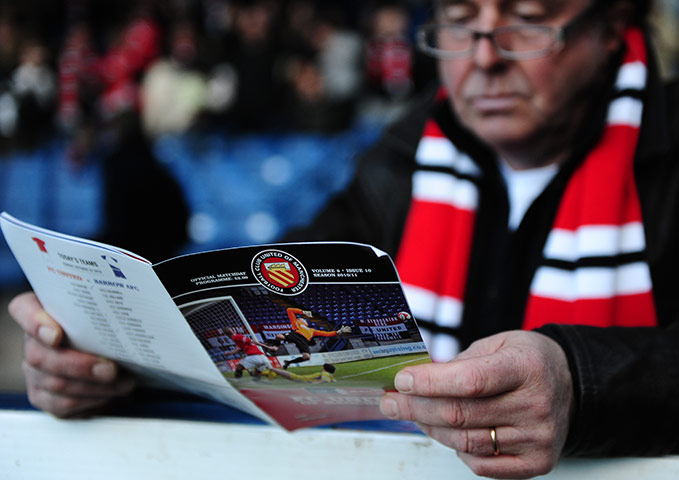FC United: An FC United of Manchester fan reads his match programme