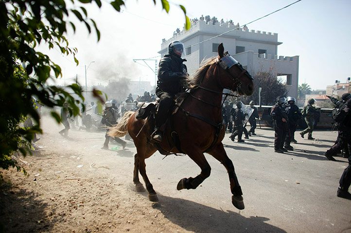 Israel Protest: A horse mounted riot police officer advances during clashes in Umm el-Fahm