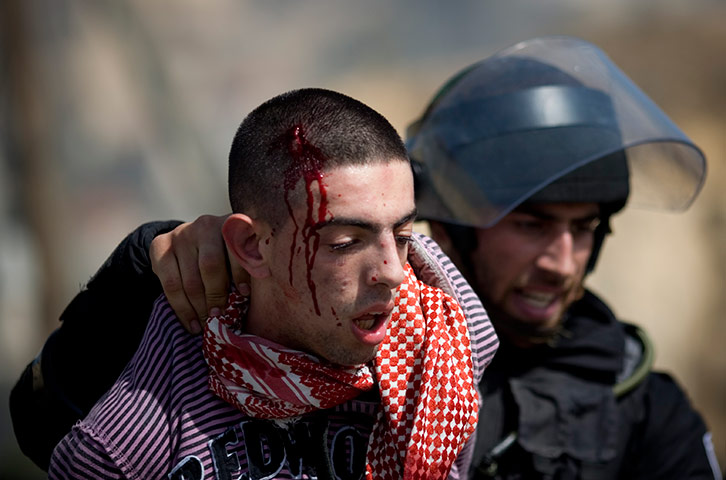 Israel Protest: An Israeli riot police officer detains Arab Israeli protester, Umm el-Fahm
