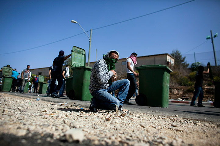 Israel Protest: An Israeli Arab collects stones during the riots in Umm el-Fahm