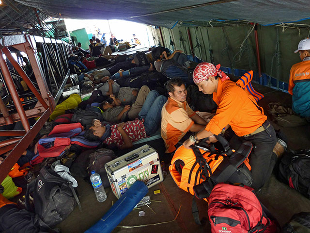Indonesia Update: Members of a rescue team ride on a ship bringing aid, Indonesia